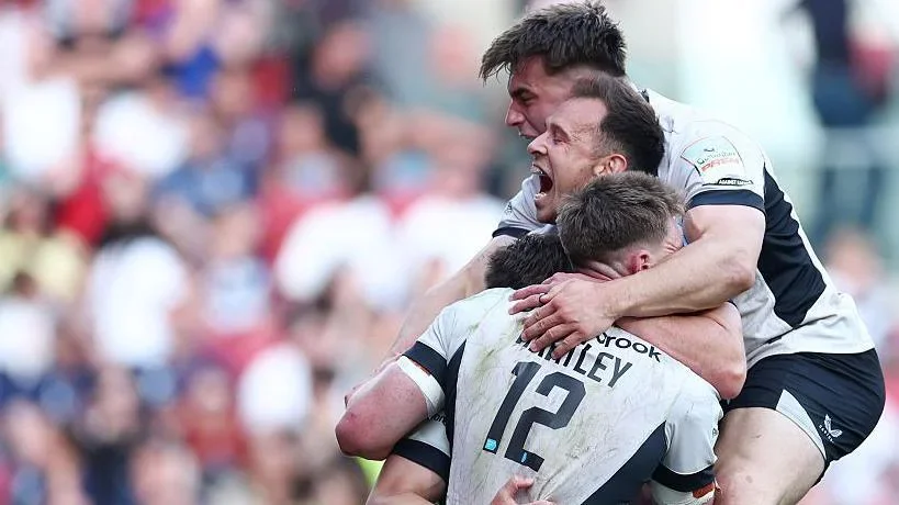 Tobias Elliott yells in delight as he hugs his team-mates in celebration of scoring  a late try to seal their win over Bristol.